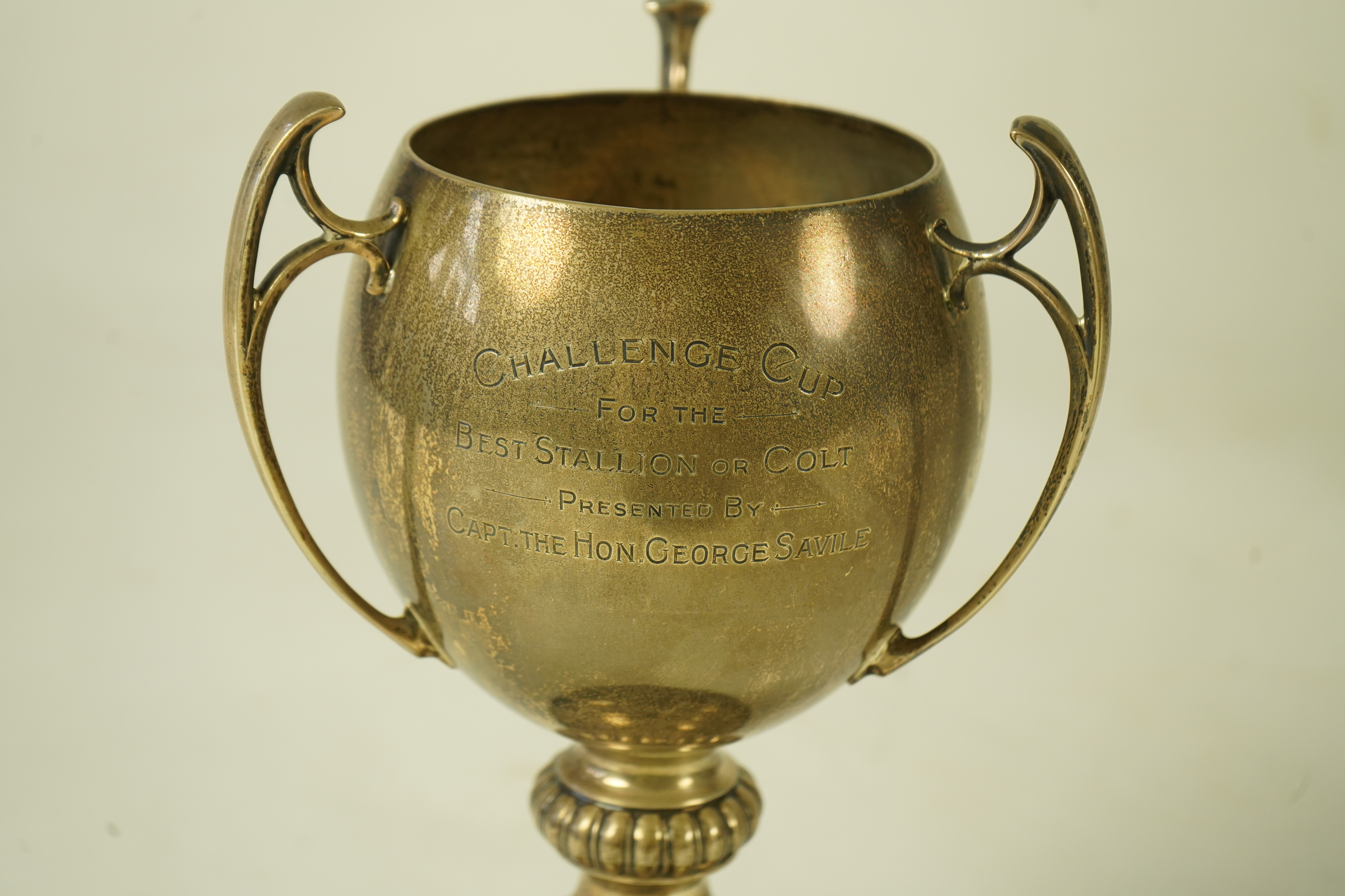 A George V silver tri-handled presentation pedestal trophy cup, with engraved horse racing inscription relating to 'The Arab Horse Society Challenge Cup for the Best Stallion or Colt'